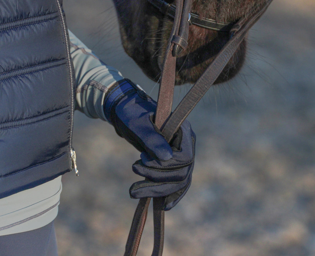 Load image into Gallery viewer, Close up of a riders hand holding reins whilst wearing the super fit riding gloves
