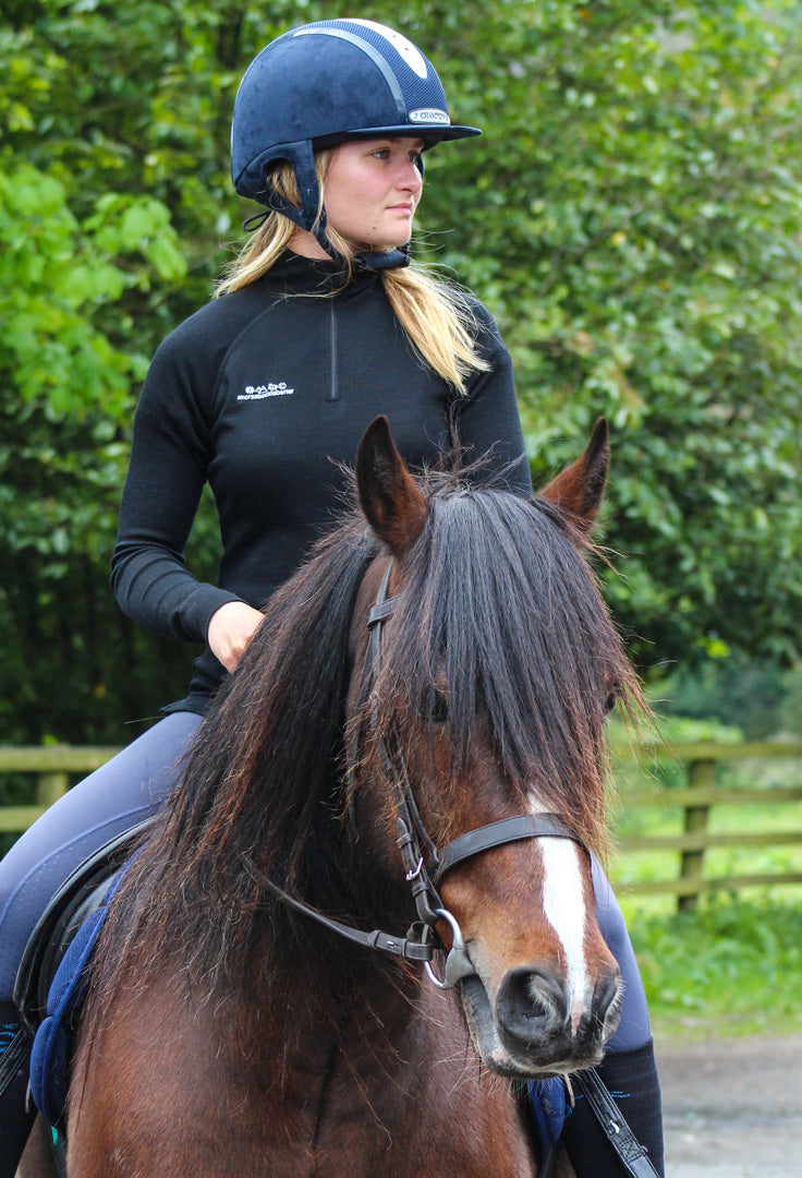 Load image into Gallery viewer, Rider wears the Keela x horsebackisbetter Merino Wool baselayer
