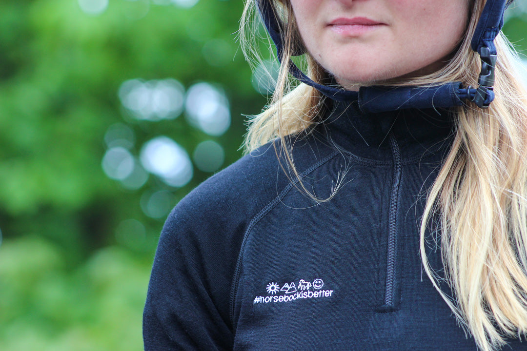 Load image into Gallery viewer, Close up of the horsebackisbetter logo on the Keela x horsebackisbetter Merino Wool baselayer
