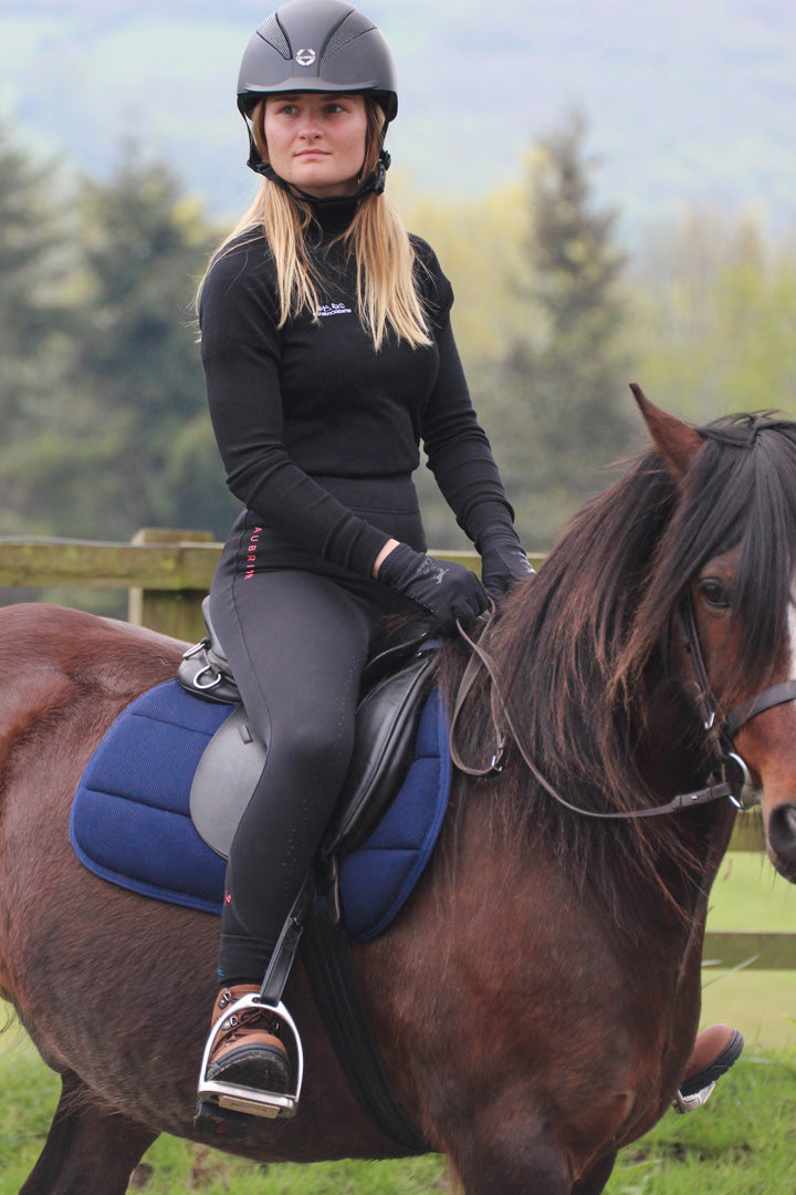 Load image into Gallery viewer, Rider wears the Keela x horsebackisbetter Merino Wool baselayer whilst riding
